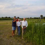 Dorothy and John Tiedje with friend on rural property