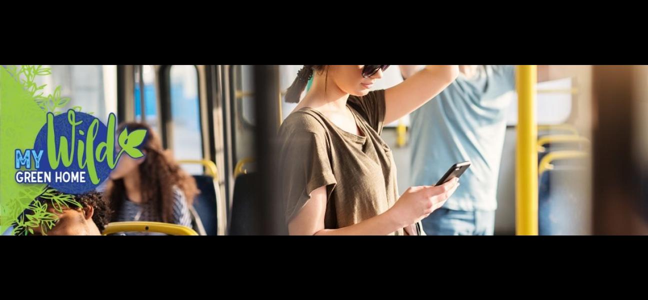 A close up of a woman texting while commuting on a city bus.